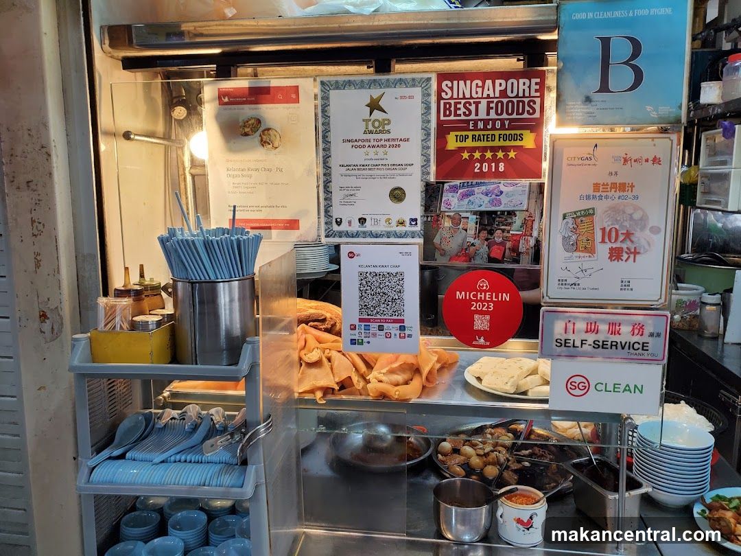 Food stall interior with awards and signage