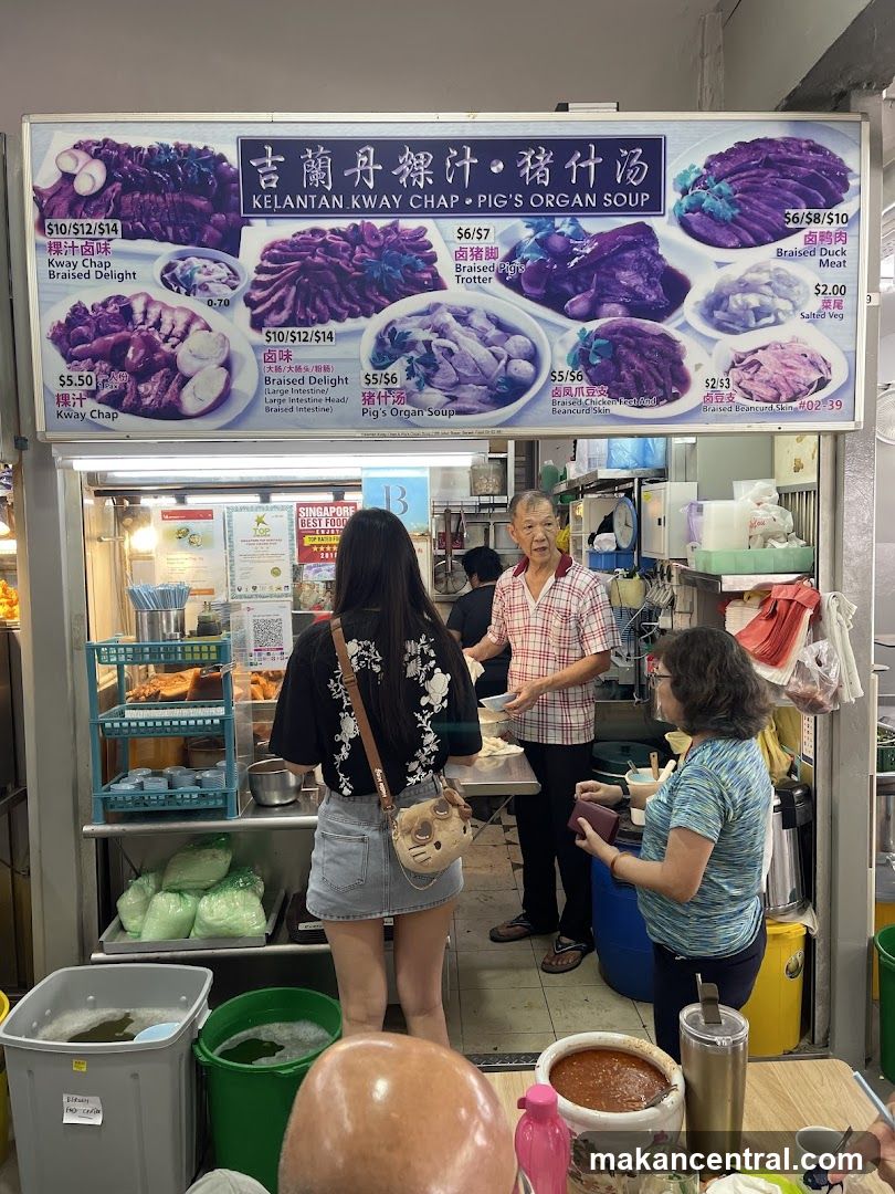 Food stall interior with customers and staff
