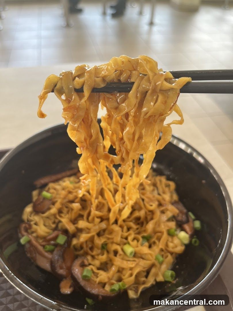 Noodles being lifted with chopsticks