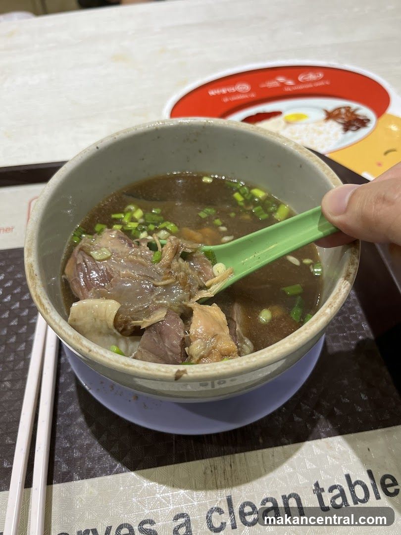 Bowl of soup with green spoon
