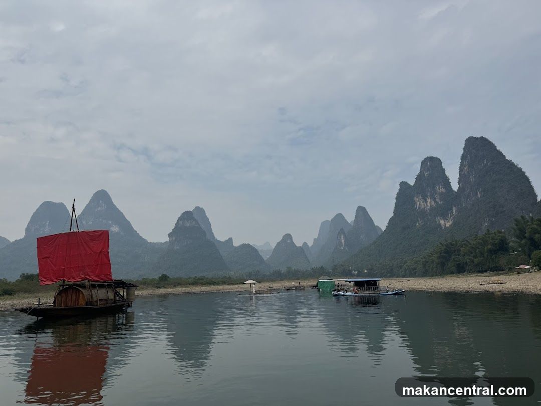 River Scene with Traditional Boat and Karst Mountains