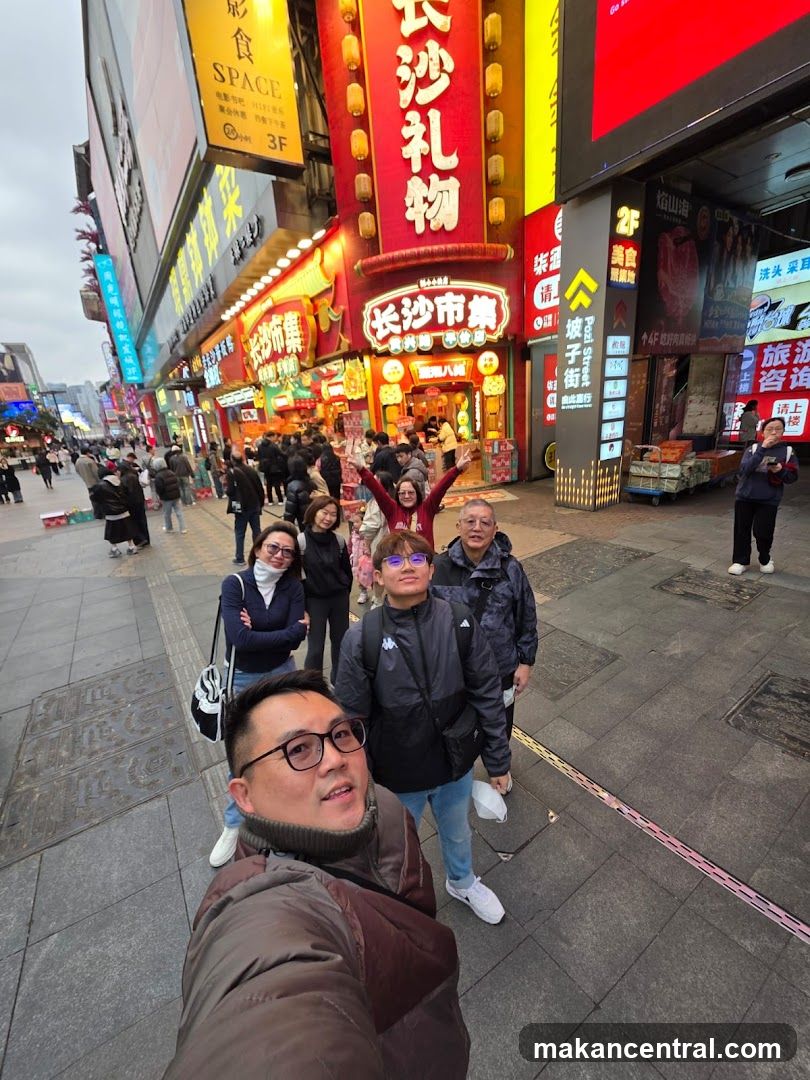 Group selfie on busy street
