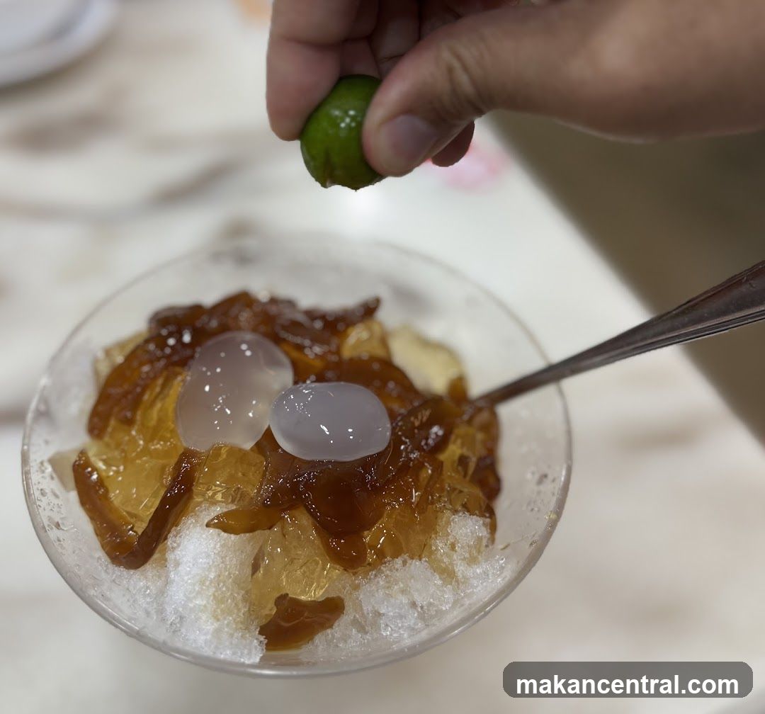 Hand squeezing lime over dessert