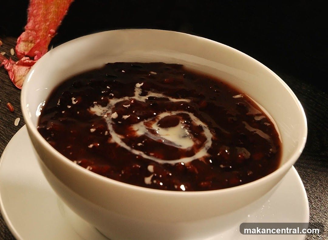Bowl of dark soup with cream swirl