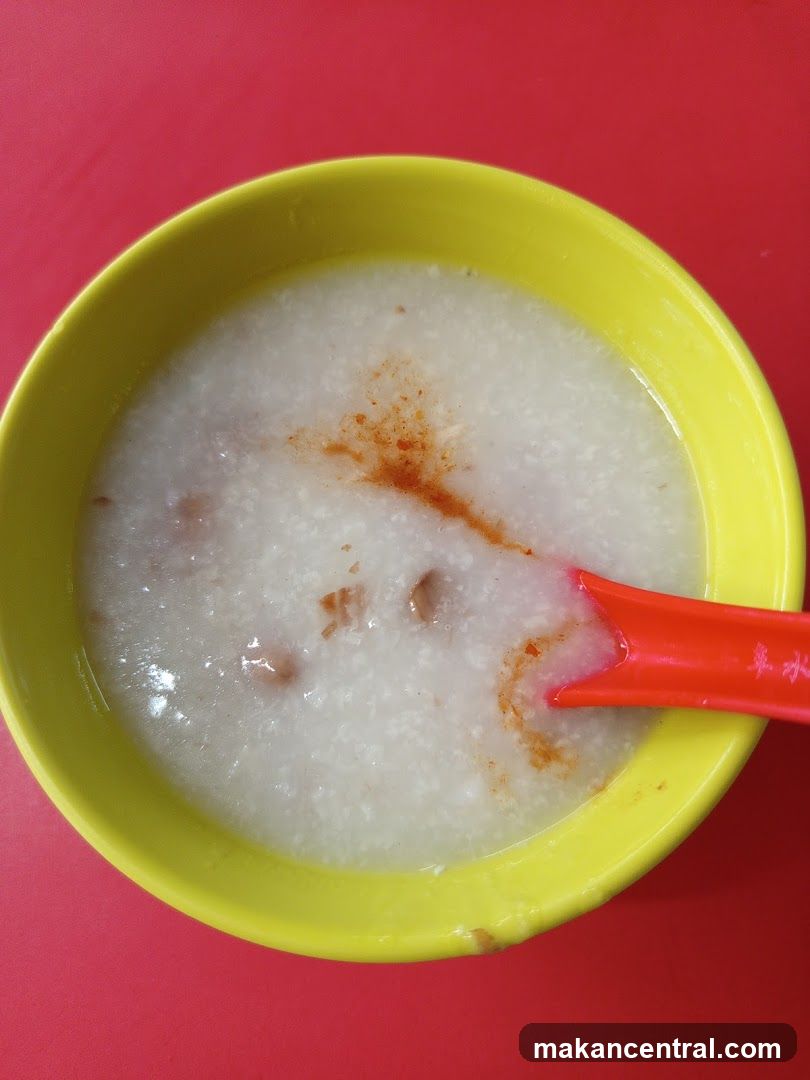 Bowl of congee with red chili sauce