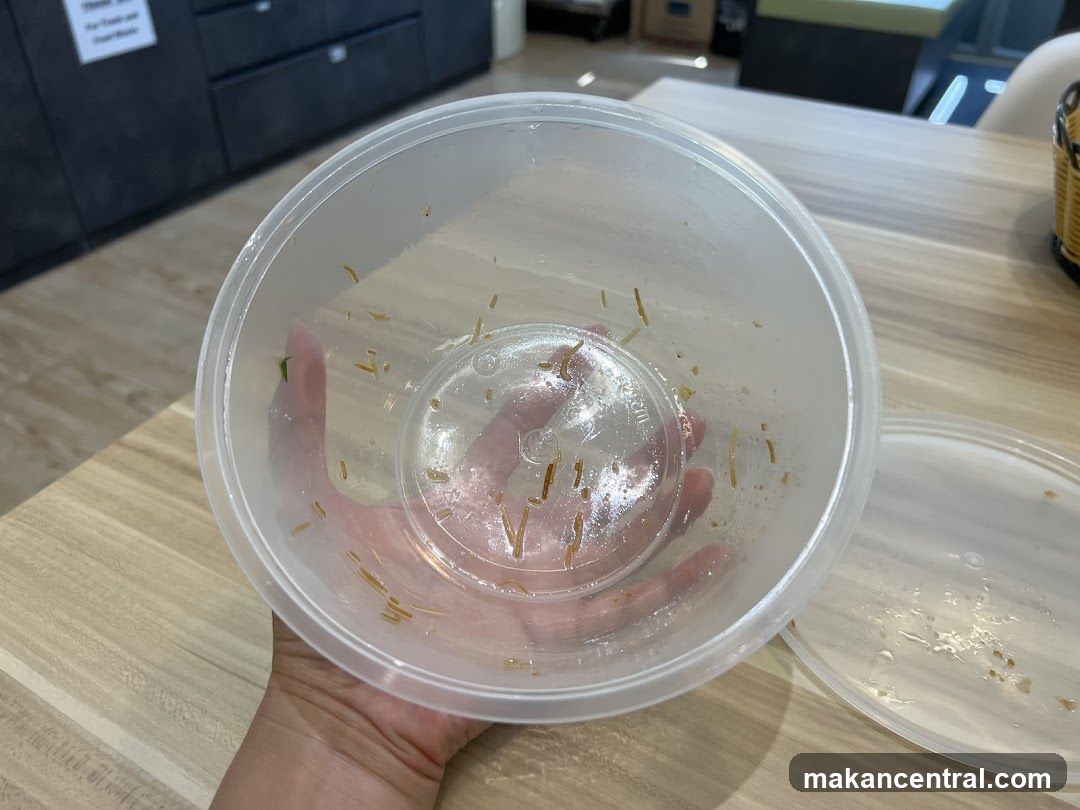 Hand holding empty food container