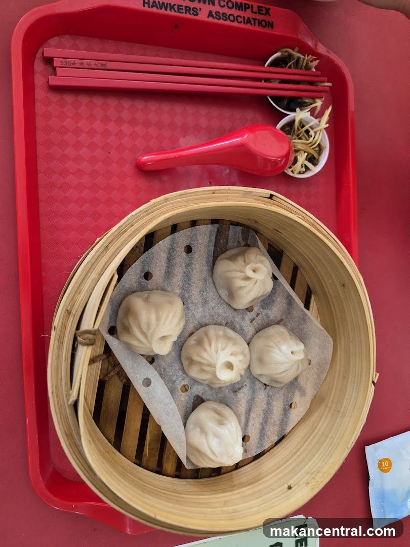 Dumplings on red tray with condiments