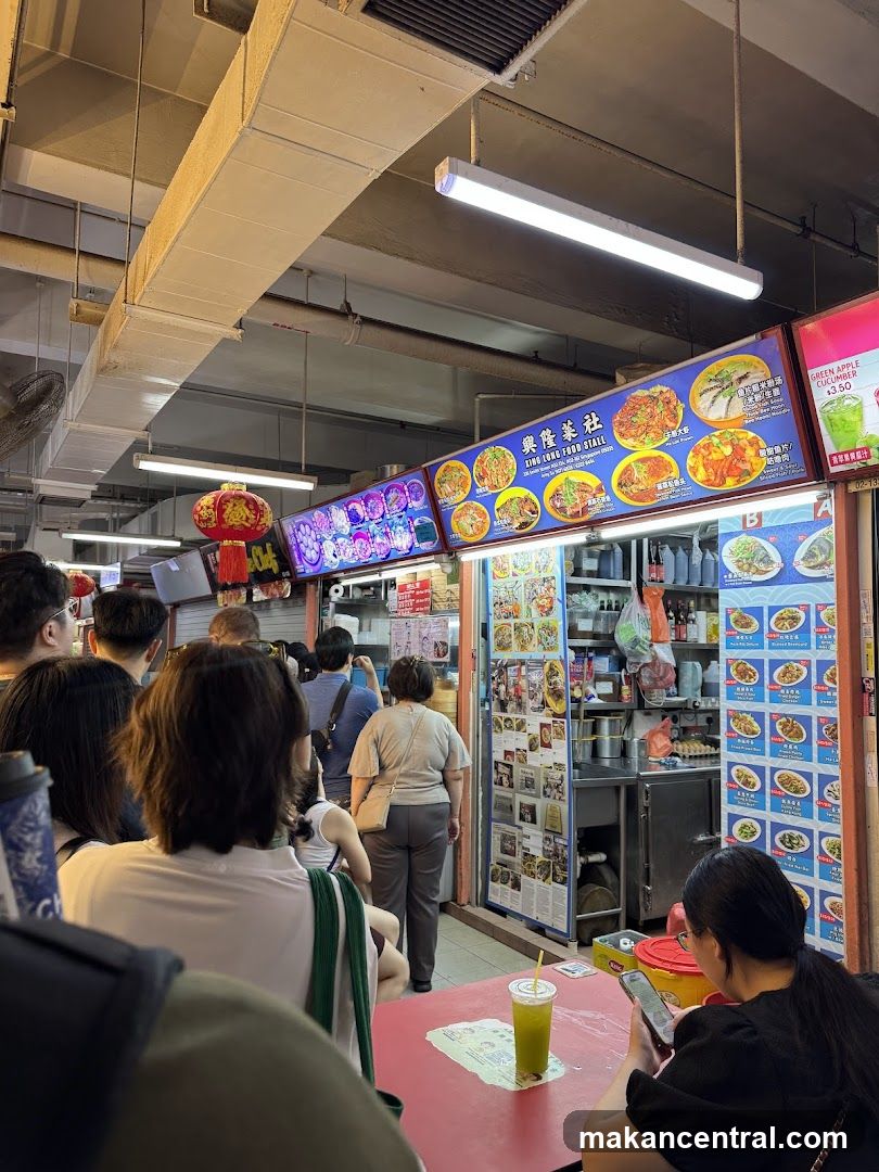 Food stall interior with customers and signage