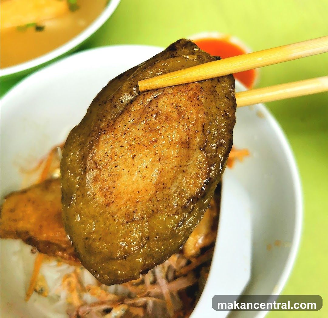 Food Item Being Held with Chopsticks