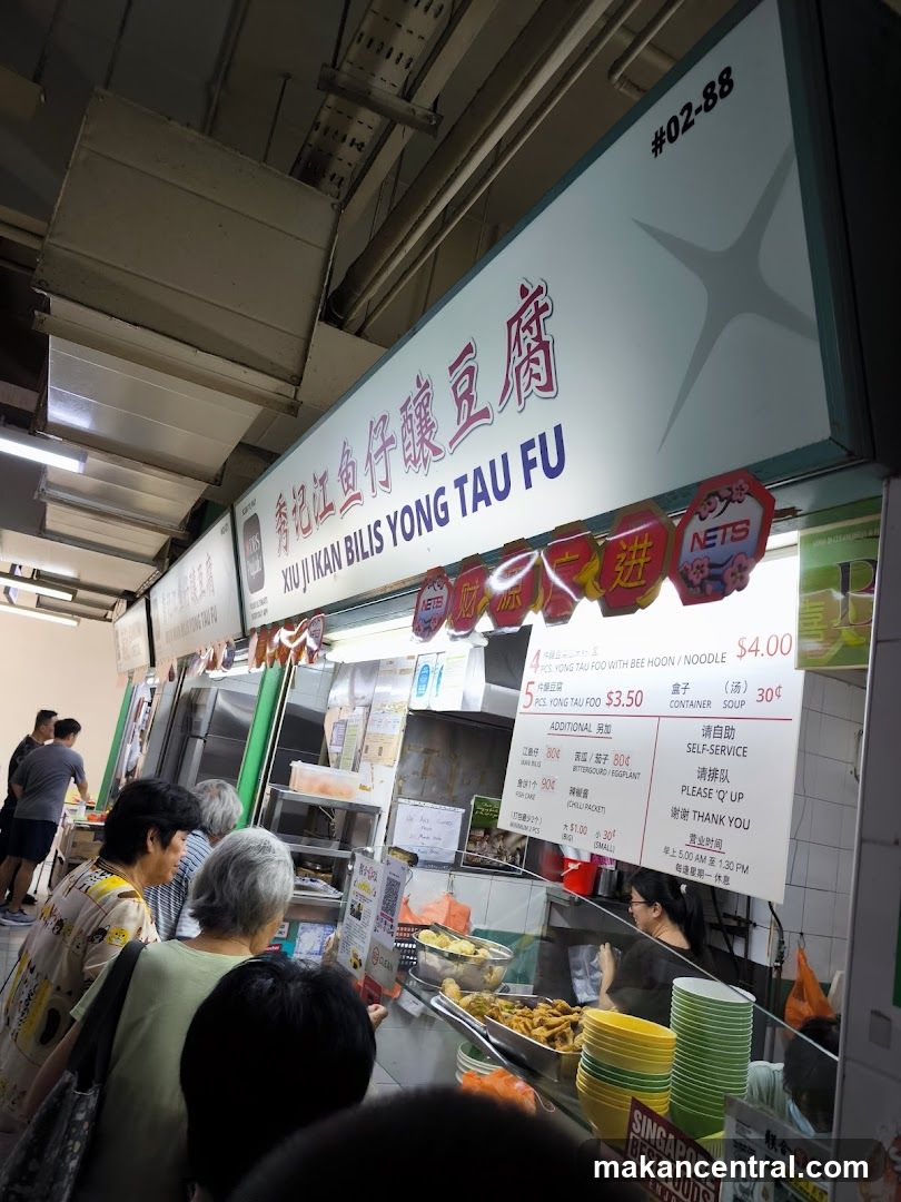 Food stall interior with customers and staff