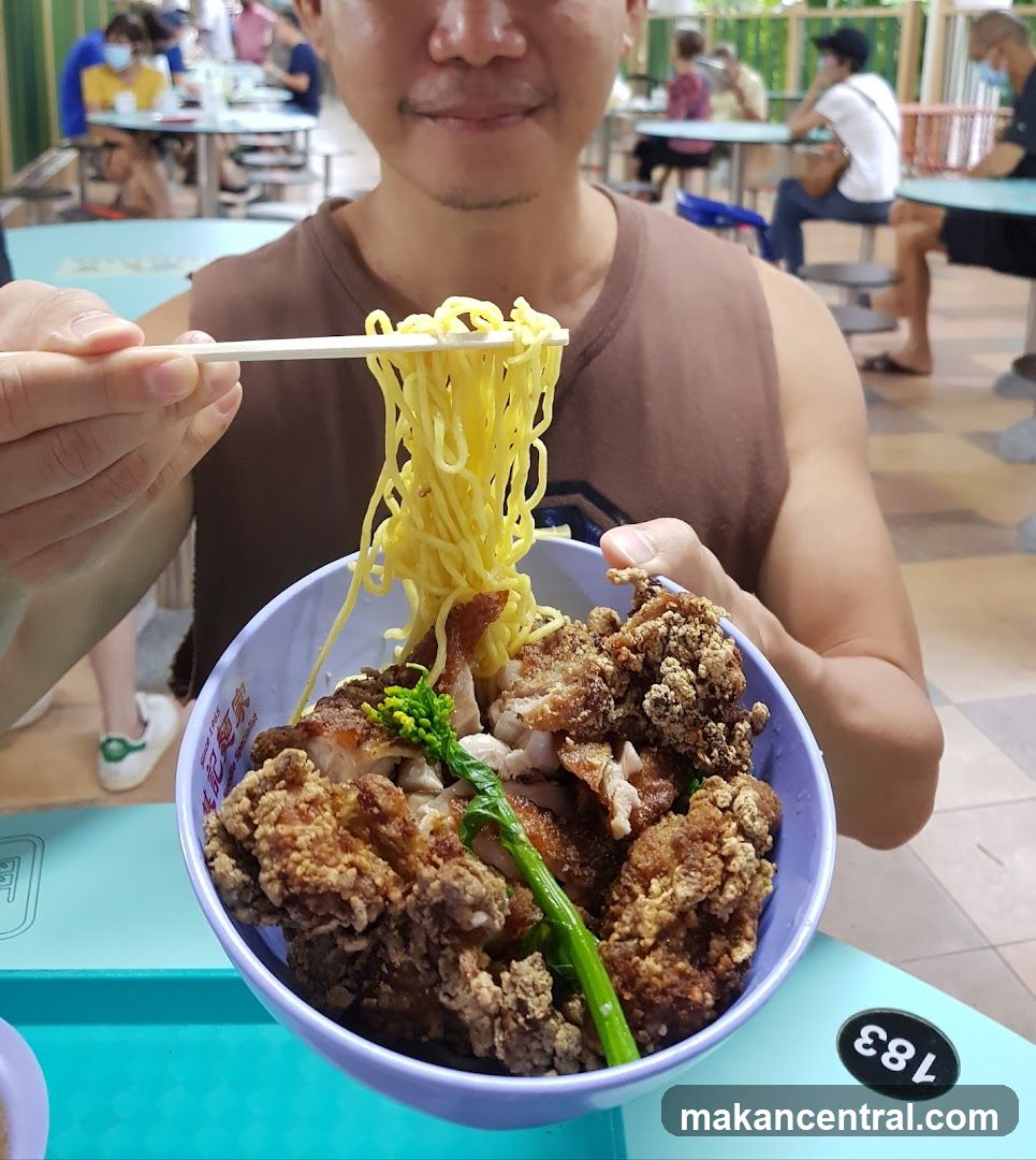 Person eating noodles at food court