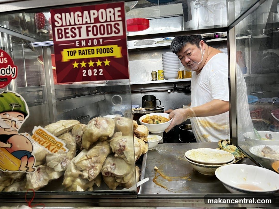 Food stall interior with chef preparing dish