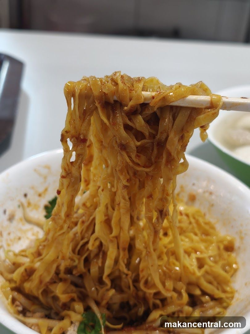 Noodles being lifted with chopsticks