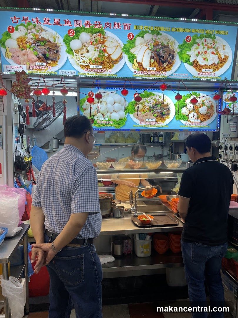 Food stall interior with customers and staff