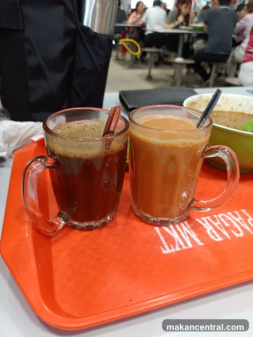 Two cups of beverages on a tray in a food court
