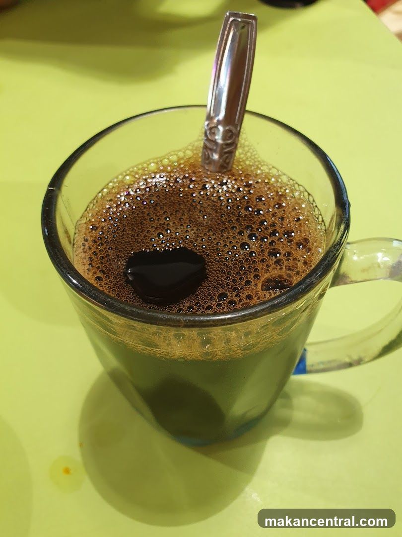 Coffee in a glass mug with spoon
