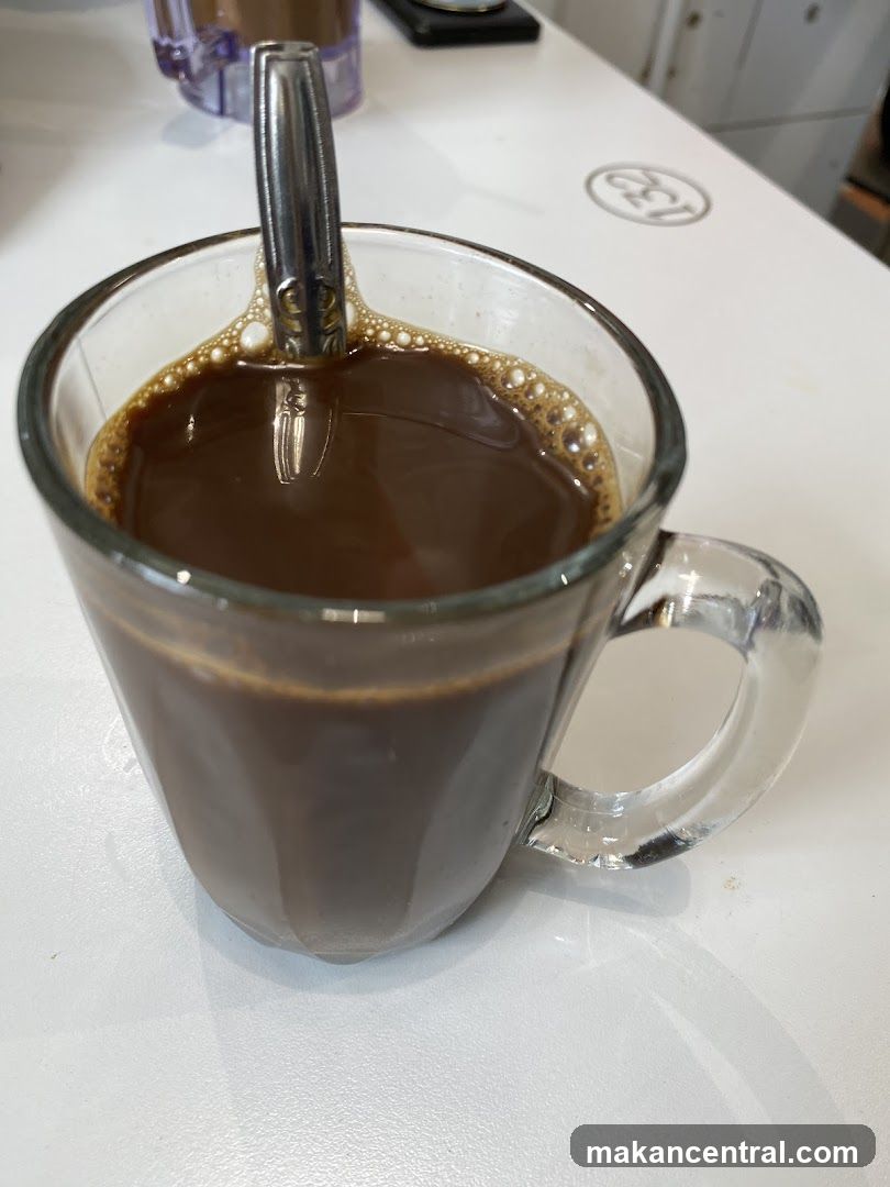 Coffee in glass mug with spoon
