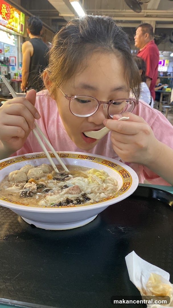 Person eating at food stall