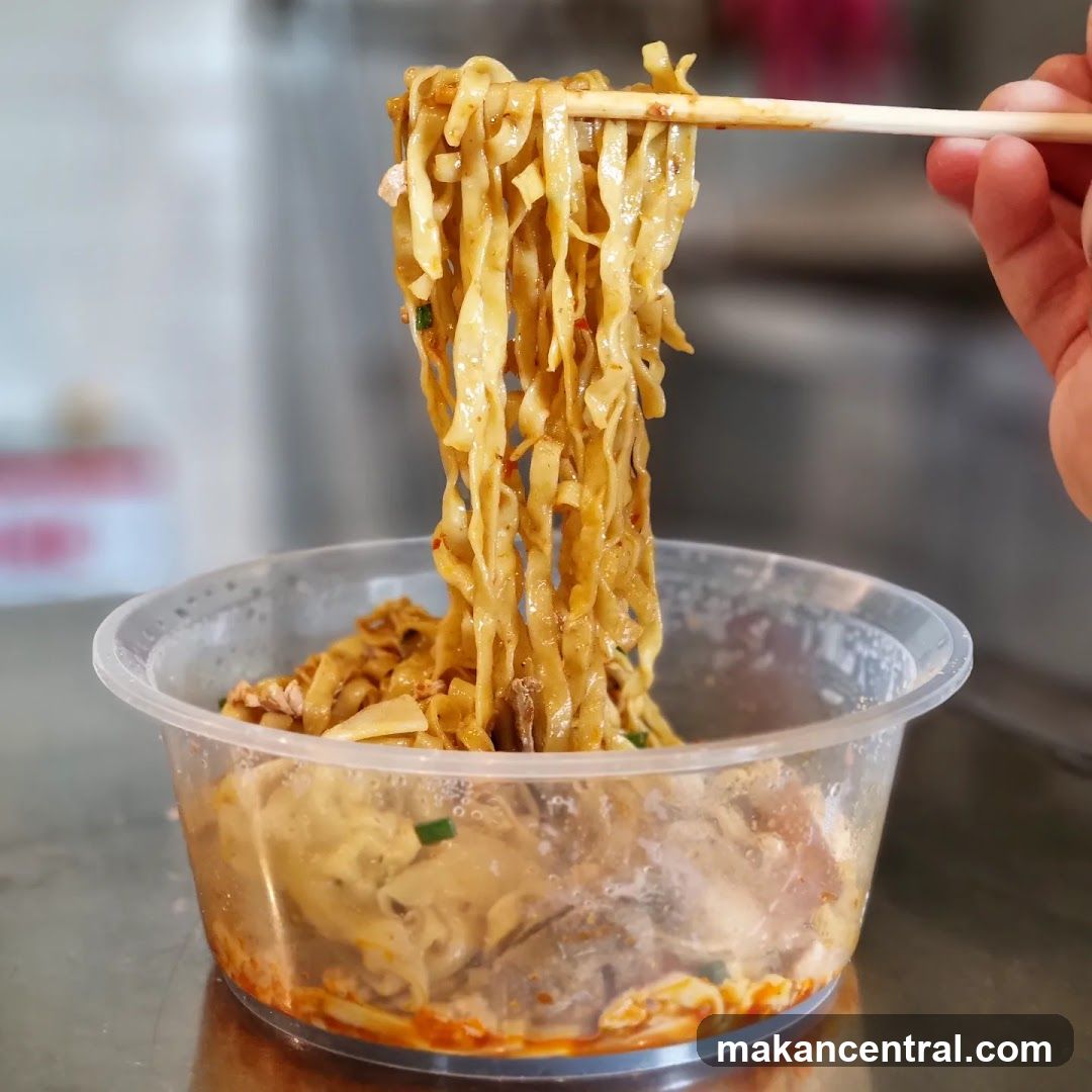 Noodles being lifted with chopsticks