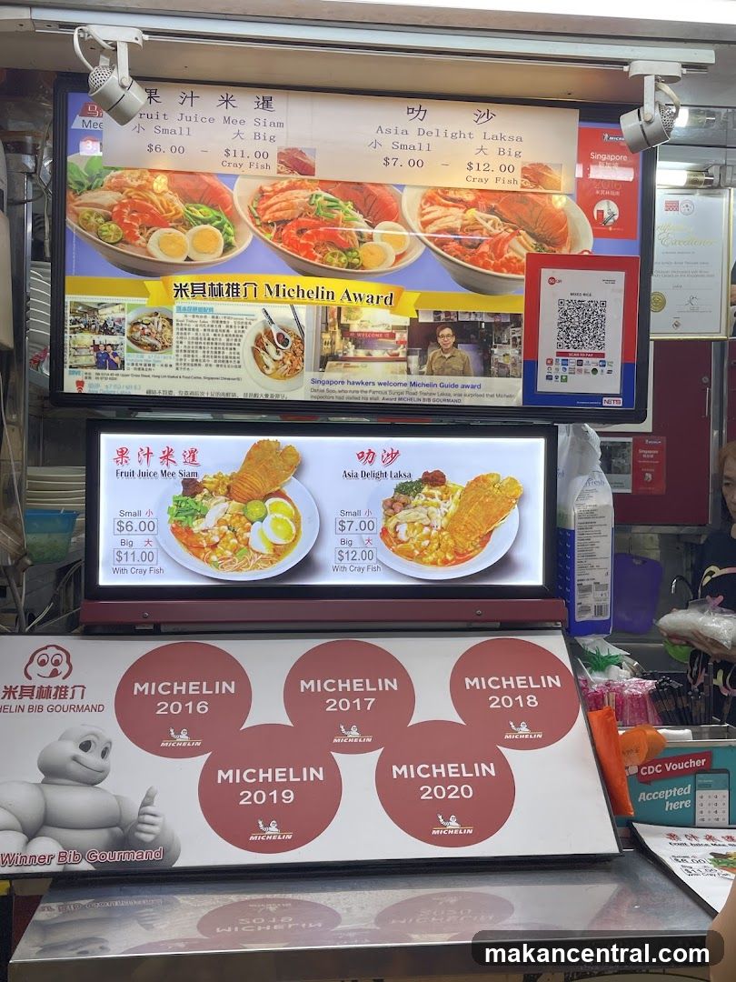 Food stall interior with Michelin awards display
