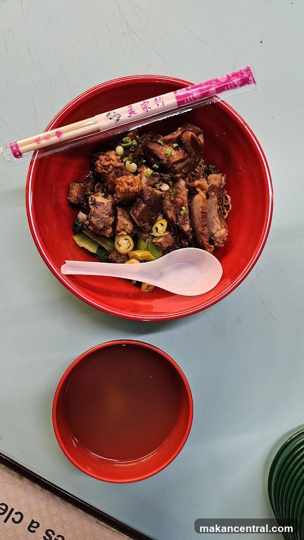 Food served in red bowl with chopsticks and spoon