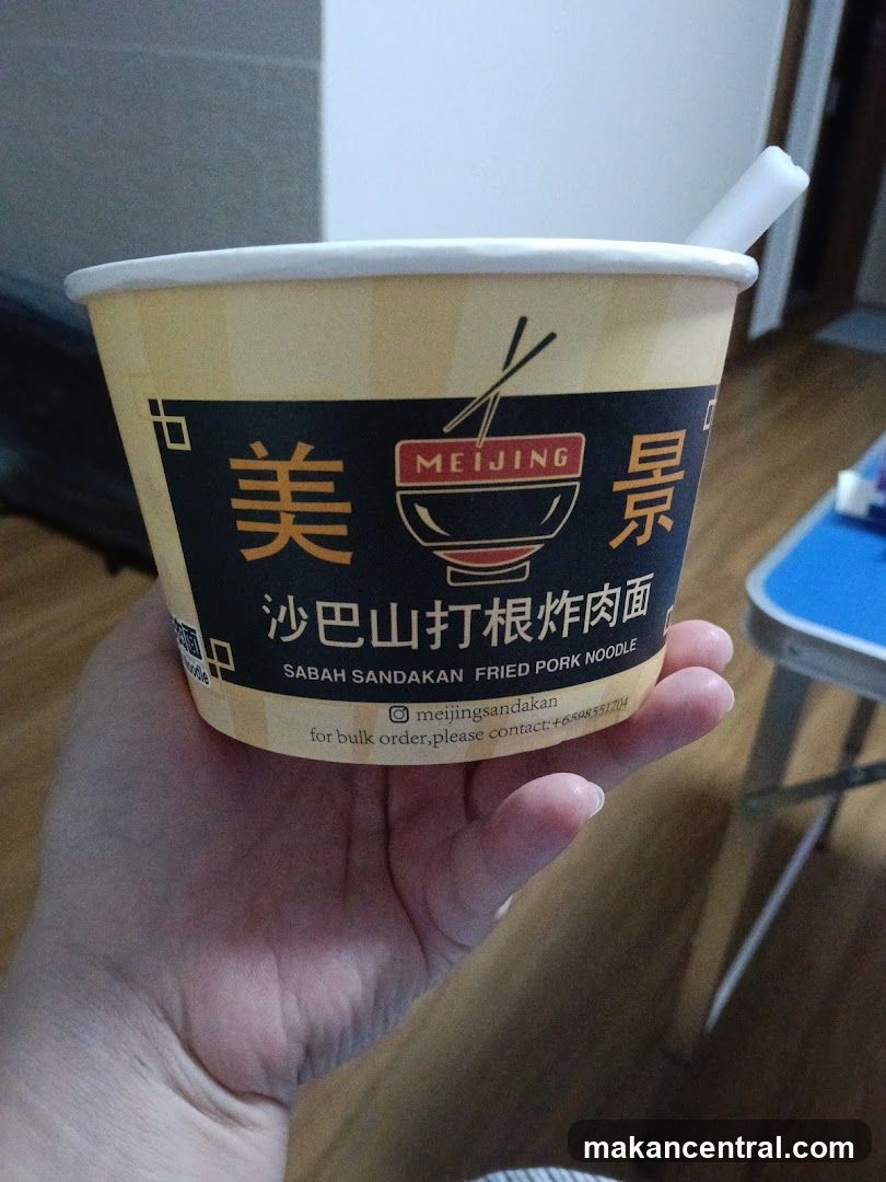 Hand holding noodle cup