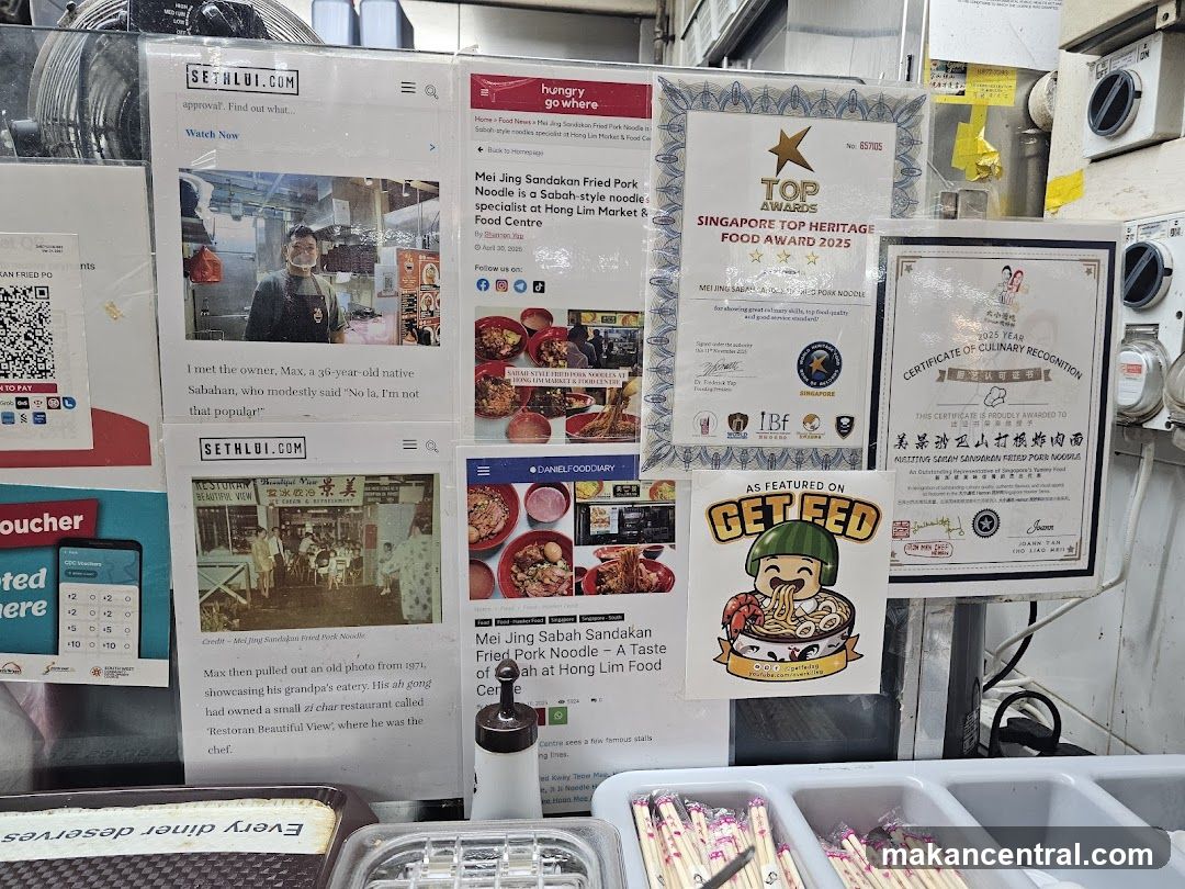Promotional posters and awards at a food stall