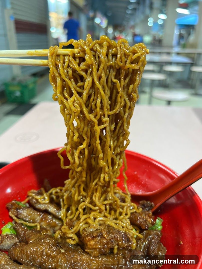 Noodles with meat in red bowl