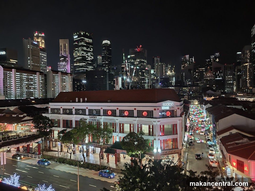 Nighttime urban view with illuminated buildings and street