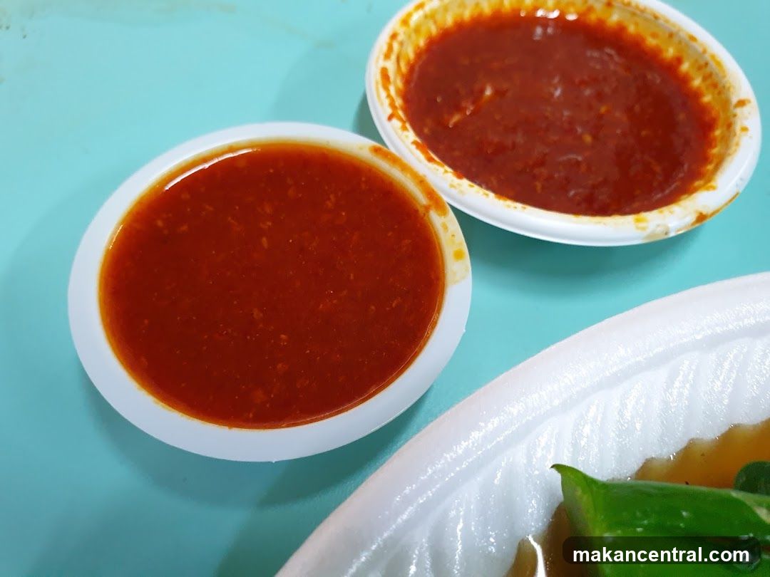 Two bowls of red sauce on a turquoise surface