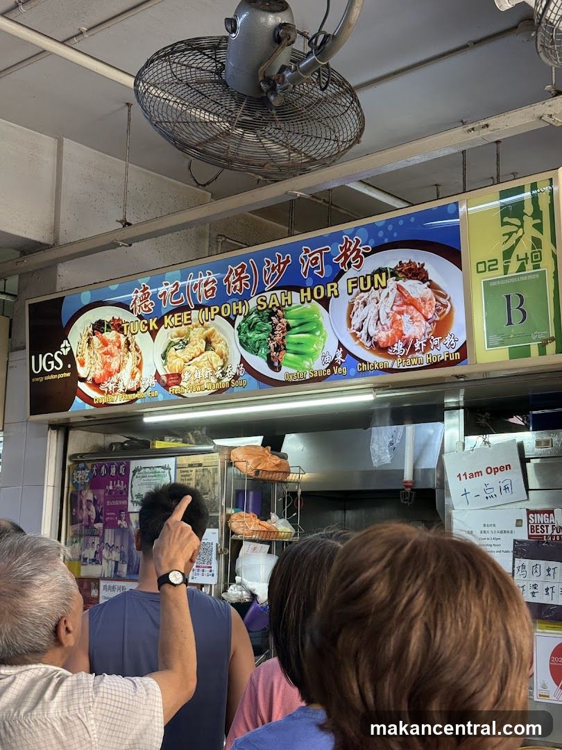 Food stall with customers and signage