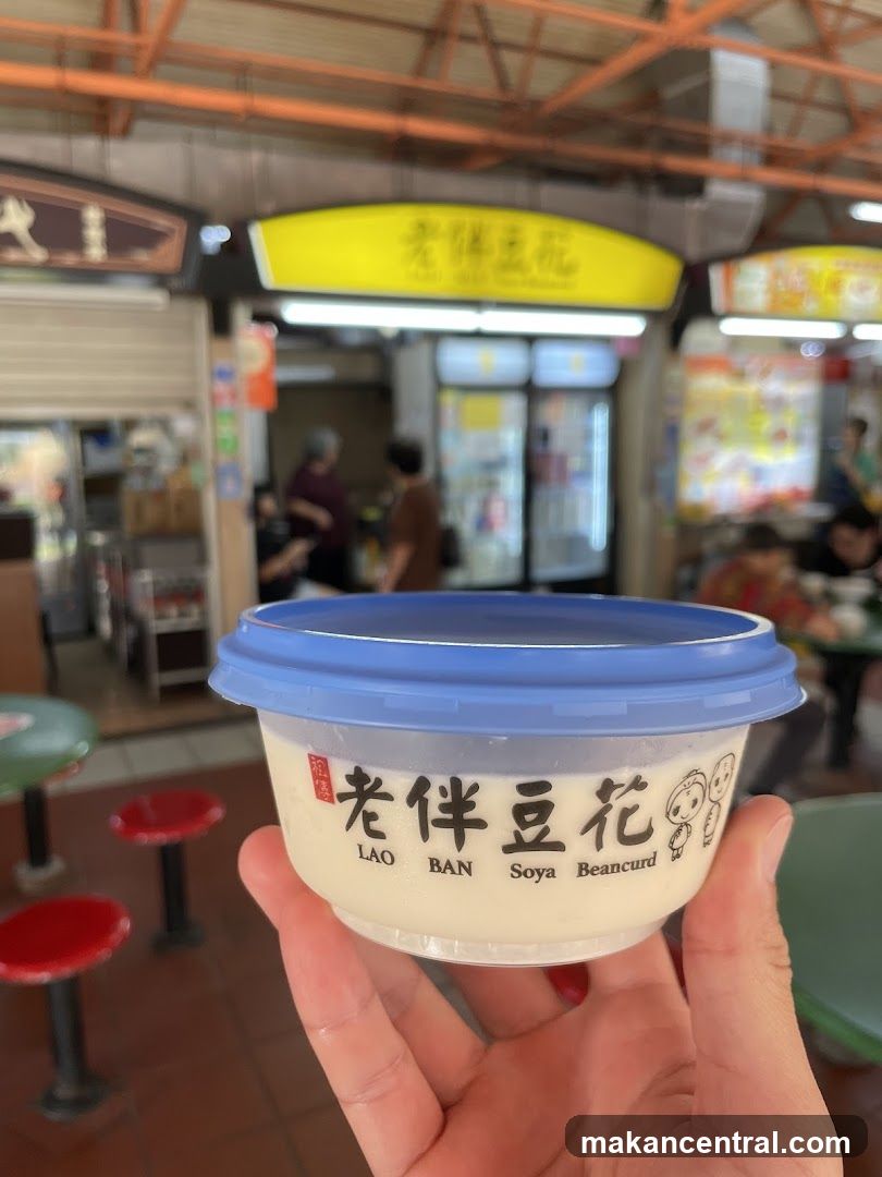 Hand holding soya bean curd cup in food court