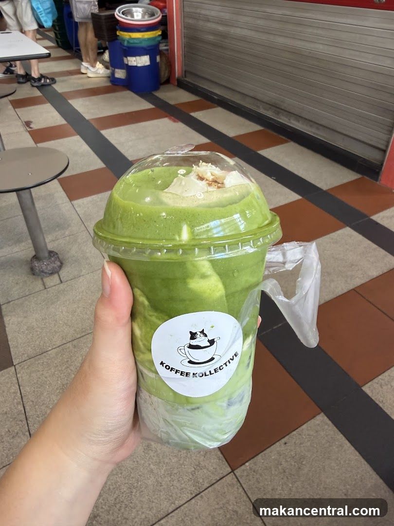 Hand holding a green beverage cup