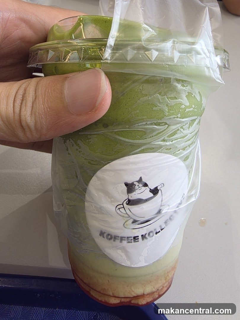 Hand holding a drink from Koffee Kollektiv