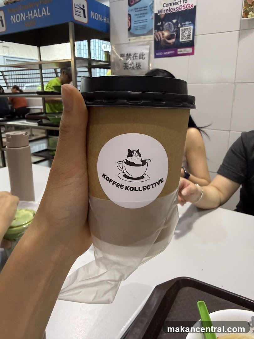 Hand holding coffee cup from Koffee Kollektive