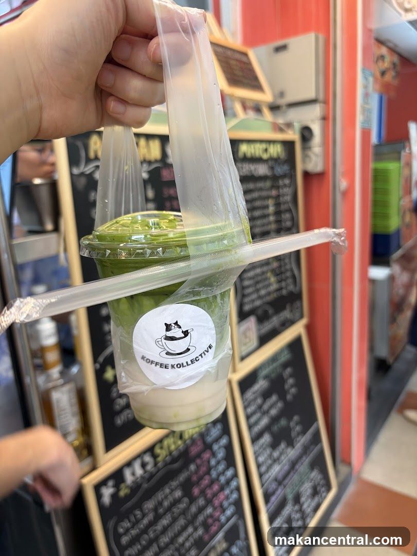 Hand holding a drink from KOFFEE KOLLEKTIVE