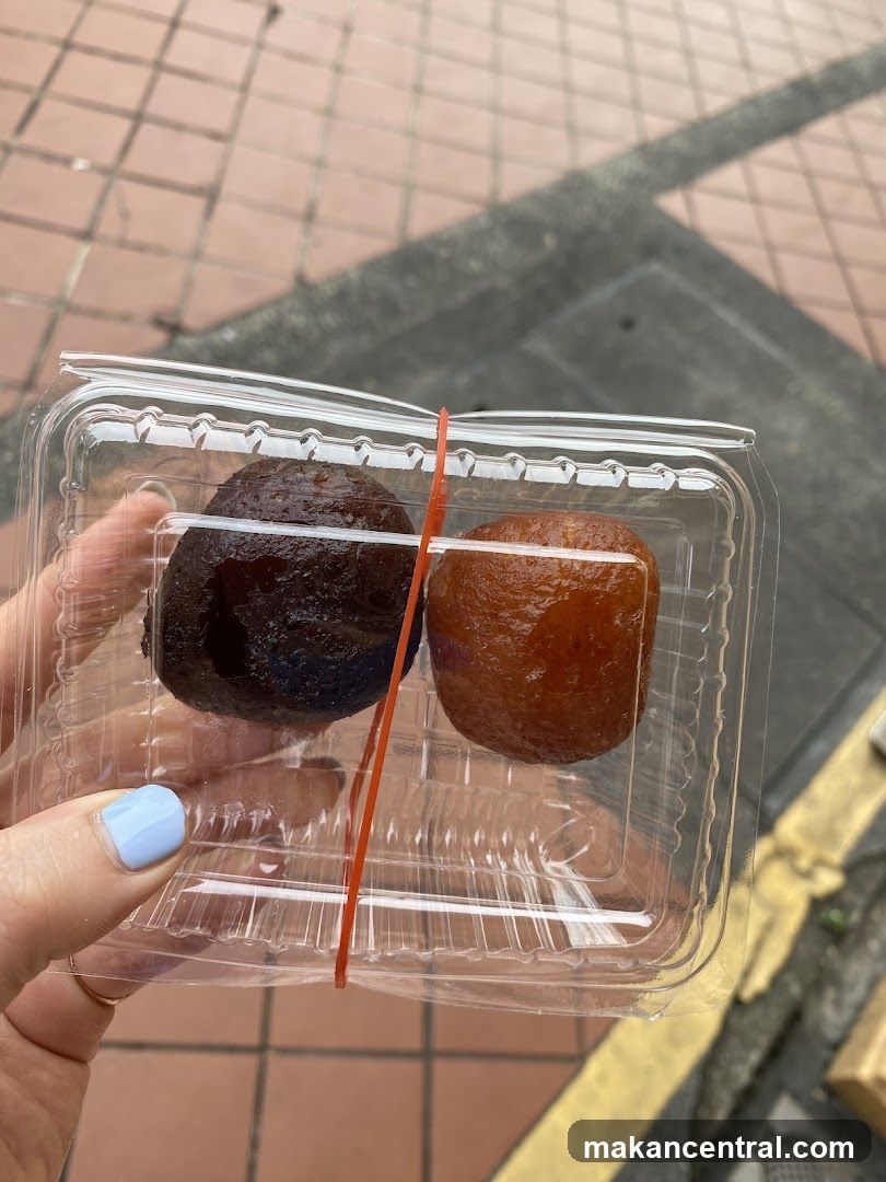 Two Gulab Jamun in a Plastic Container