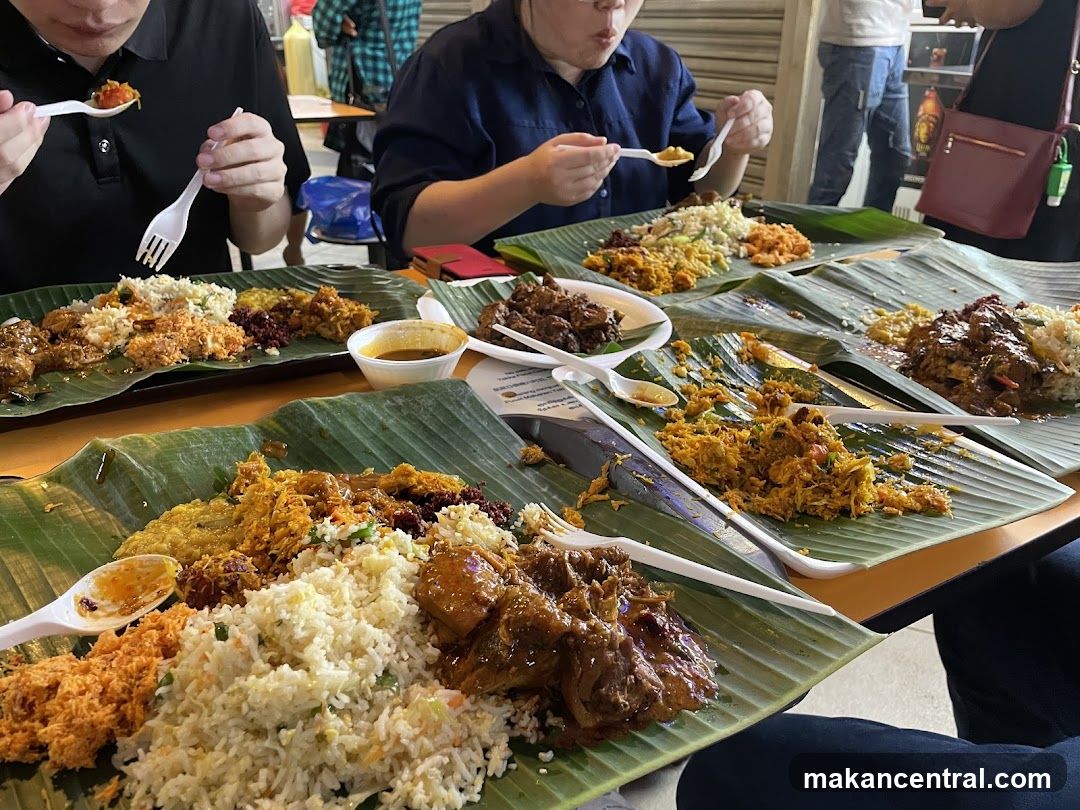 People Eating Meals on Banana Leaves