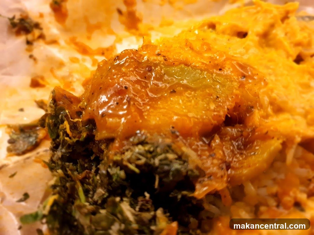 Close-up of a dish with rice, greens, and a saucy topping