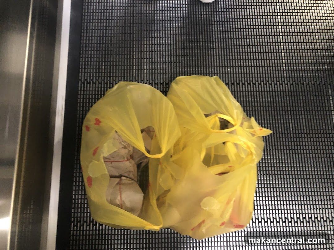 Two yellow plastic bags on an escalator