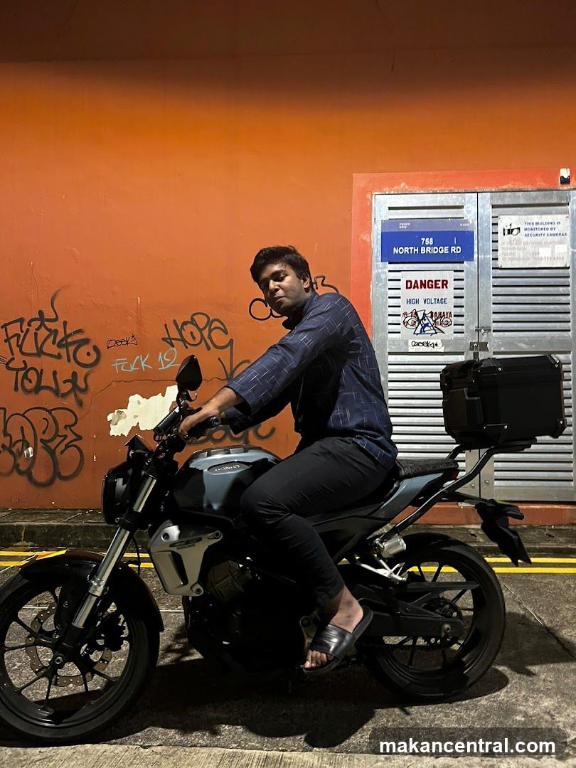 Man on Motorcycle in Front of Graffiti-Covered Wall