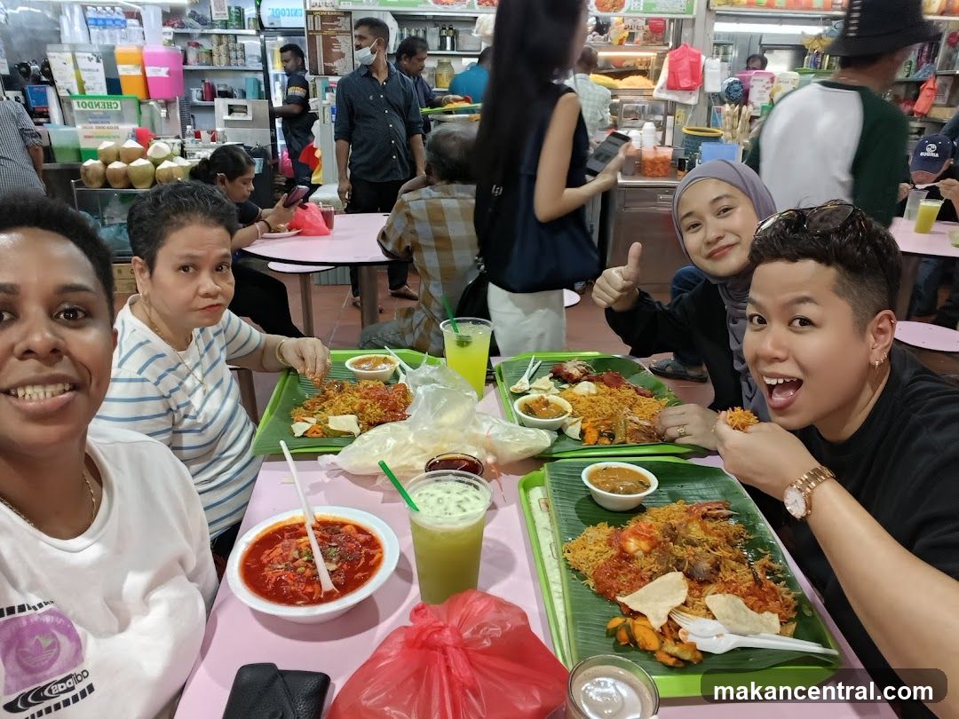 People enjoying a meal at a food stall