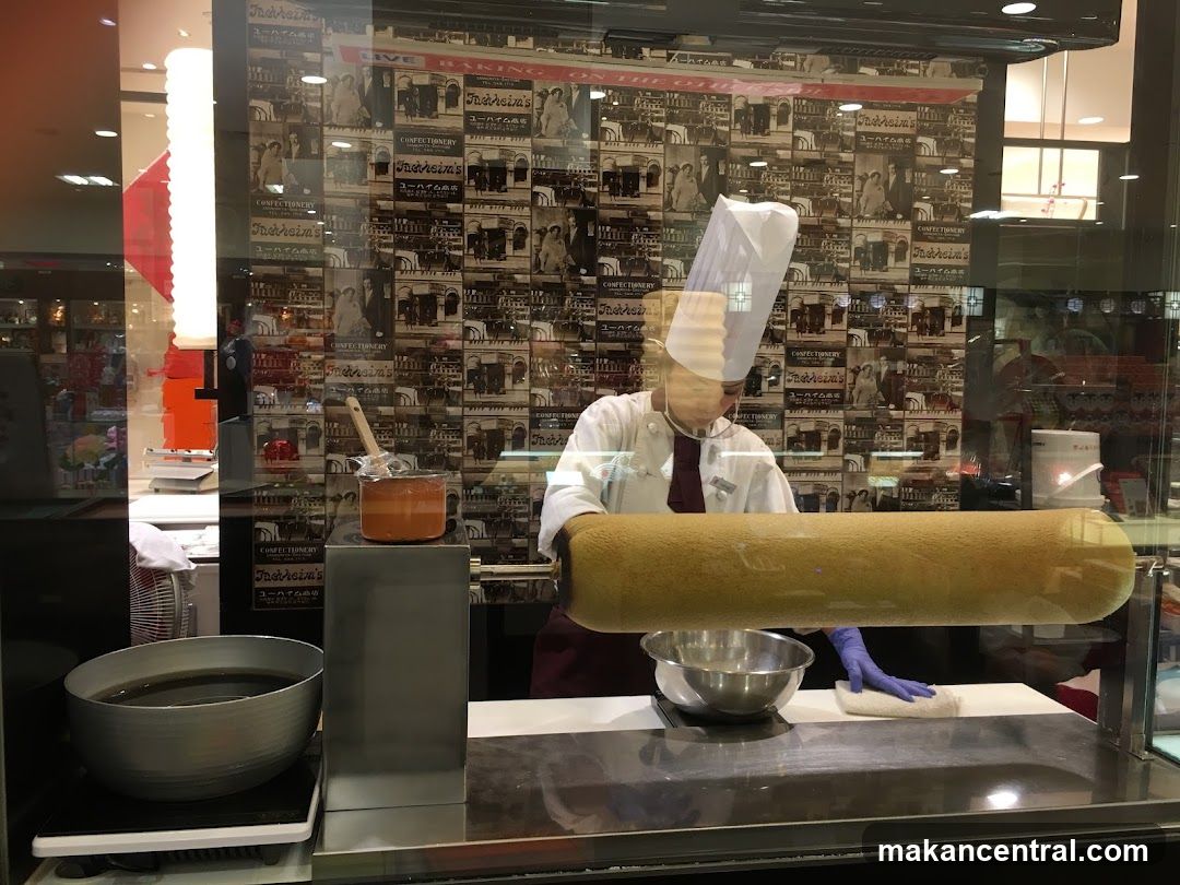 Baker preparing a large cake