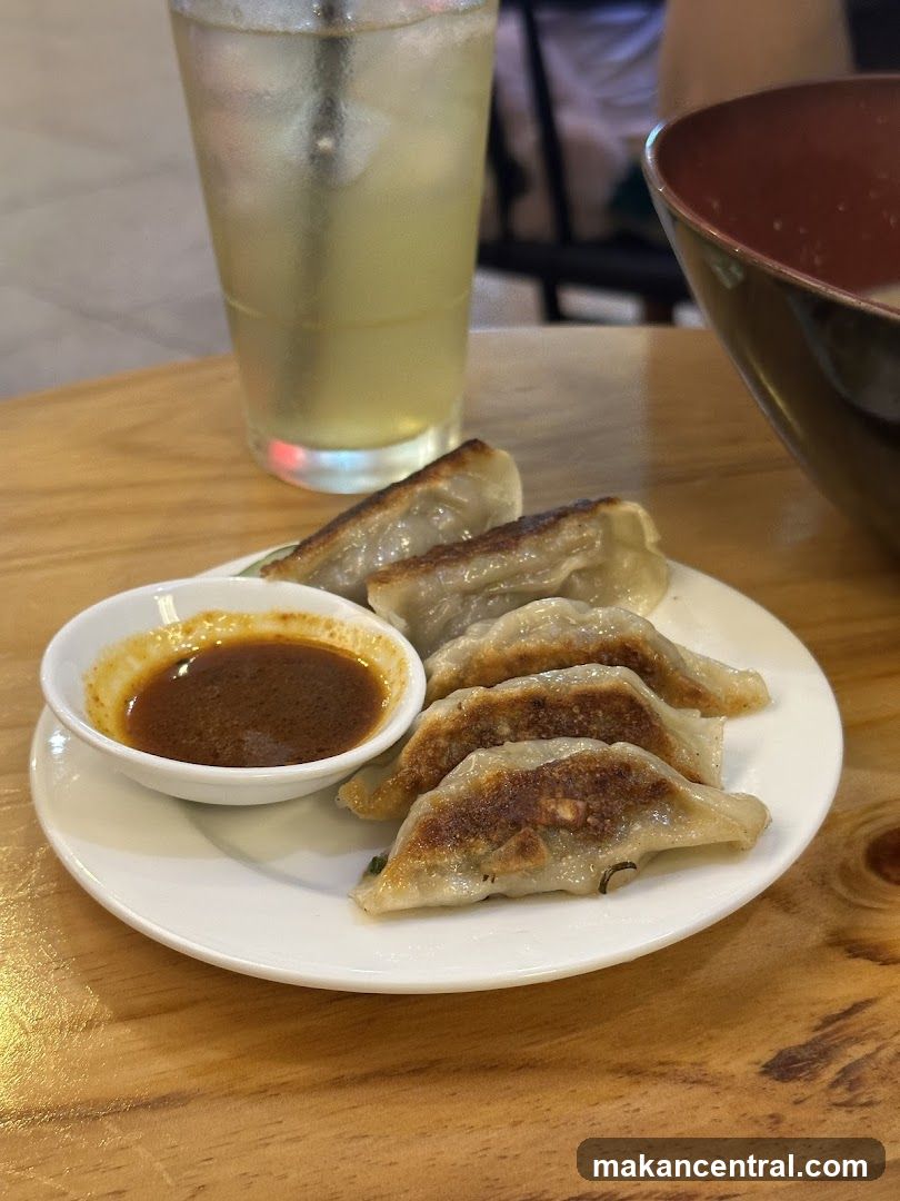 Pan-fried dumplings with dipping sauce