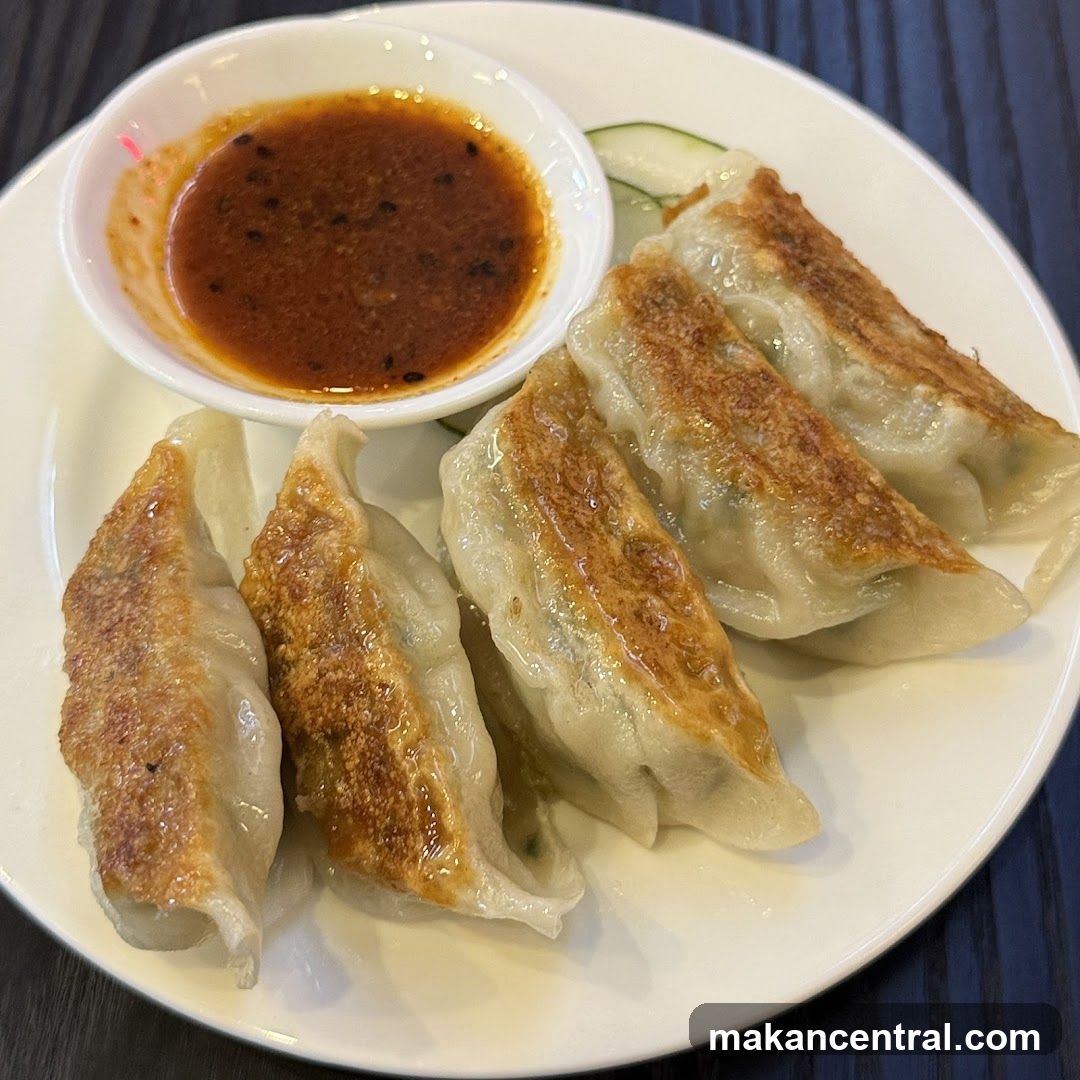 Pan-fried dumplings with dipping sauce