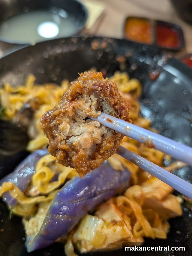 Close-up of a Meatball with Noodles and Eggplant