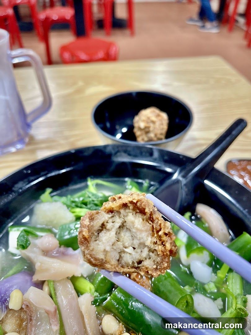 Close-up of a fried meatball in a soup