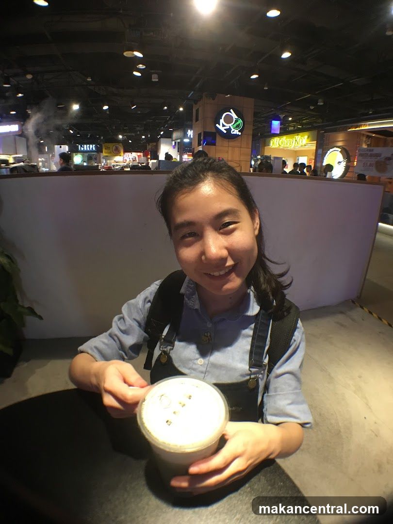Woman with a drink at a food court