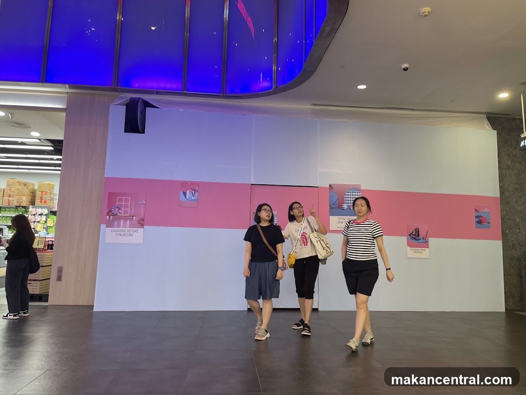 People walking past a display wall