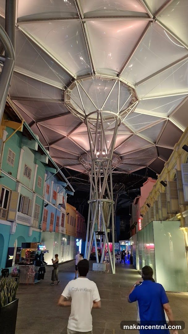 Outdoor walkway with colorful buildings and modern canopy